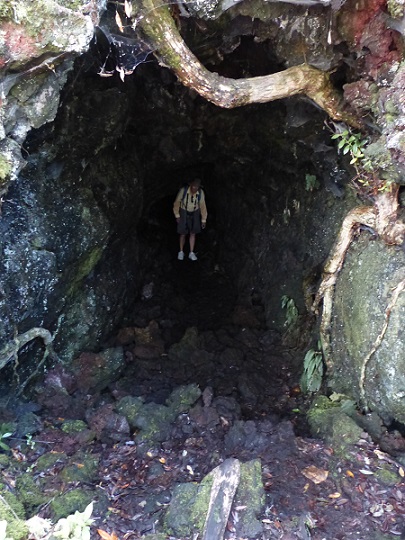 Randall emerges from a lava tunnel on Rangitoto